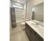 Clean bathroom featuring a vanity with a granite countertop, shower, and tiled floors at 8949 Sw 76Th St, Ocala, FL 34481