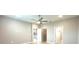 Spacious bedroom featuring a ceiling fan, neutral paint, and access to closets and other rooms at 8949 Sw 76Th St, Ocala, FL 34481