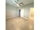 Spacious bedroom featuring a ceiling fan and a walk-in closet for ample storage at 8949 Sw 76Th St, Ocala, FL 34481