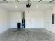 Spacious two car garage with white walls, concrete floors, and two doors at 8949 Sw 76Th St, Ocala, FL 34481