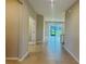 Inviting hallway with neutral colors and tile flooring leading to the open living area at 8949 Sw 76Th St, Ocala, FL 34481
