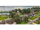 Scenic aerial view of homes near a serene lake with lush greenery, docks, and a playground at 911 Beverly Harbors Dr # 16, Leesburg, FL 34748