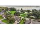 Scenic aerial view of homes near a serene lake with lush greenery, docks, and boats at 911 Beverly Harbors Dr # 16, Leesburg, FL 34748