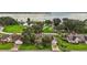 A beautiful aerial view of waterfront homes with lush landscaping, driveways, and a tranquil lake at 911 Beverly Harbors Dr # 16, Leesburg, FL 34748