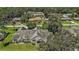 Aerial view of a well-maintained home with a green lawn and mature trees in a suburban setting at 911 Beverly Harbors Dr # 16, Leesburg, FL 34748