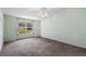 Bright bedroom with carpet, large window and neutral wall color at 911 Beverly Harbors Dr # 16, Leesburg, FL 34748