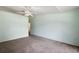 Spacious bedroom features neutral carpet, ceiling fan and large closet at 911 Beverly Harbors Dr # 16, Leesburg, FL 34748