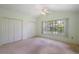 Bedroom with carpet and double closets at 911 Beverly Harbors Dr # 16, Leesburg, FL 34748