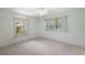 Light bedroom featuring carpet, ceiling fan and two windows at 911 Beverly Harbors Dr # 16, Leesburg, FL 34748