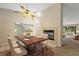 Cozy dining area showcasing a fireplace, wooden table, and ample natural light at 911 Beverly Harbors Dr # 16, Leesburg, FL 34748