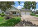 Charming single-story home with a well-manicured lawn, covered porch with swing, and two-car garage at 911 Beverly Harbors Dr # 16, Leesburg, FL 34748