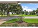 View from the front porch showcasing a lush lawn, mature trees, and scenic neighborhood park at 911 Beverly Harbors Dr # 16, Leesburg, FL 34748