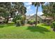 Charming single-story home with mature landscaping and a lush green lawn on a sunny day at 911 Beverly Harbors Dr # 16, Leesburg, FL 34748