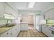 Inviting kitchen featuring white appliances, ample cabinet space, and a seamless view to the connecting living room at 911 Beverly Harbors Dr # 16, Leesburg, FL 34748