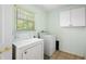 Laundry room features washer, dryer, and storage cabinet at 911 Beverly Harbors Dr # 16, Leesburg, FL 34748