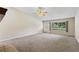 Spacious living room with neutral carpet, ceiling fan, and large windows offering natural light at 911 Beverly Harbors Dr # 16, Leesburg, FL 34748