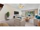 Bright living room featuring a vaulted ceiling, neutral colors, and natural light from a large window at 911 Beverly Harbors Dr # 16, Leesburg, FL 34748