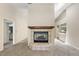 Bright living room featuring a tile-framed fireplace, neutral walls, and doorways leading to other areas of the home at 911 Beverly Harbors Dr # 16, Leesburg, FL 34748