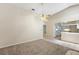 Spacious living room featuring a ceiling fan, neutral walls and view to the kitchen through a bar opening at 911 Beverly Harbors Dr # 16, Leesburg, FL 34748