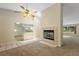 This living room features high ceilings with a ceiling fan and a fireplace with tile surround at 911 Beverly Harbors Dr # 16, Leesburg, FL 34748