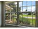 Window view of the exterior features lush green landscaping and a glimpse of the neighboring community lake at 911 Beverly Harbors Dr # 16, Leesburg, FL 34748