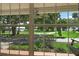View of lush outdoor scenery and park through a large window from inside the home at 911 Beverly Harbors Dr # 16, Leesburg, FL 34748
