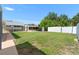 Large backyard with shed, boat lift and lush green grass at 10431 Reagans Run Dr, Clermont, FL 34711