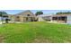 Expansive backyard featuring lush green grass, covered patio, grill, and boat storage, perfect for outdoor entertainment at 10431 Reagans Run Dr, Clermont, FL 34711