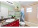 Hall bathroom features a tub and shower, and a vanity with granite countertop at 10431 Reagans Run Dr, Clermont, FL 34711