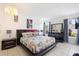 The main bedroom has a large bed, dark furniture, and tile flooring at 10431 Reagans Run Dr, Clermont, FL 34711