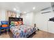 This room has a large bed, toys, a ceiling fan, and tile floors at 10431 Reagans Run Dr, Clermont, FL 34711