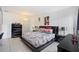 The main bedroom has a large bed, dark furniture, and tile flooring at 10431 Reagans Run Dr, Clermont, FL 34711