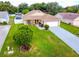 Aerial view of a well-manicured home with mature landscaping and a neutral color scheme at 10431 Reagans Run Dr, Clermont, FL 34711