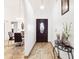 Bright foyer with stylish tile flooring and an elegant front door, leading to the home's interior at 10431 Reagans Run Dr, Clermont, FL 34711