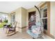 Cozy front porch featuring comfortable seating and a charming hanging chair, perfect for relaxing outdoors at 10431 Reagans Run Dr, Clermont, FL 34711