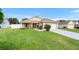 Charming single-story home with a well-maintained lawn, inviting curb appeal, and an attached two-car garage at 10431 Reagans Run Dr, Clermont, FL 34711