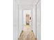 A well-lit hallway showcasing tile flooring, closet space, and access to various rooms at 10431 Reagans Run Dr, Clermont, FL 34711