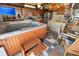 Unique entertainment area with a hot tub, full kitchen, bar, TV, and eclectic decorations at 10431 Reagans Run Dr, Clermont, FL 34711