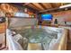 Indoor hot tub room with a TV, wood paneled ceiling, and fun decor at 10431 Reagans Run Dr, Clermont, FL 34711
