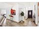 Open-concept living area with a glimpse of the kitchen, featuring stylish arches and modern lighting fixtures at 10431 Reagans Run Dr, Clermont, FL 34711