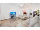 Bright living room with neutral tones, comfortable seating, and tiled floors, creating a welcoming atmosphere at 10431 Reagans Run Dr, Clermont, FL 34711