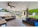 This covered patio has tile flooring and seating area and a boat in the back at 10431 Reagans Run Dr, Clermont, FL 34711