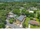This aerial shot shows the property with lush landscaping and a convenient detached carport at 1109 Edmonds St, Leesburg, FL 34748
