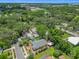 Aerial view of the property with mature trees, a carport, and a well-maintained yard at 1109 Edmonds St, Leesburg, FL 34748