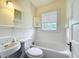 Bright bathroom features a classic white tub and stylish fixtures at 1109 Edmonds St, Leesburg, FL 34748