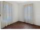 Bright bedroom with hardwood floors and light-filtering curtains at 1109 Edmonds St, Leesburg, FL 34748