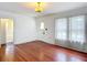 Bright bedroom with hardwood floors and large windows featuring sheer white curtains at 1109 Edmonds St, Leesburg, FL 34748