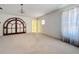 Spacious bedroom featuring a chandelier, arched doorway, and ample natural light at 1109 Edmonds St, Leesburg, FL 34748