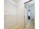 Walk-in closet adjacent to bathroom features ample shelving and storage space at 1109 Edmonds St, Leesburg, FL 34748