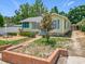 Charming yellow home featuring a brick walkway and lush, green landscaping at 1109 Edmonds St, Leesburg, FL 34748